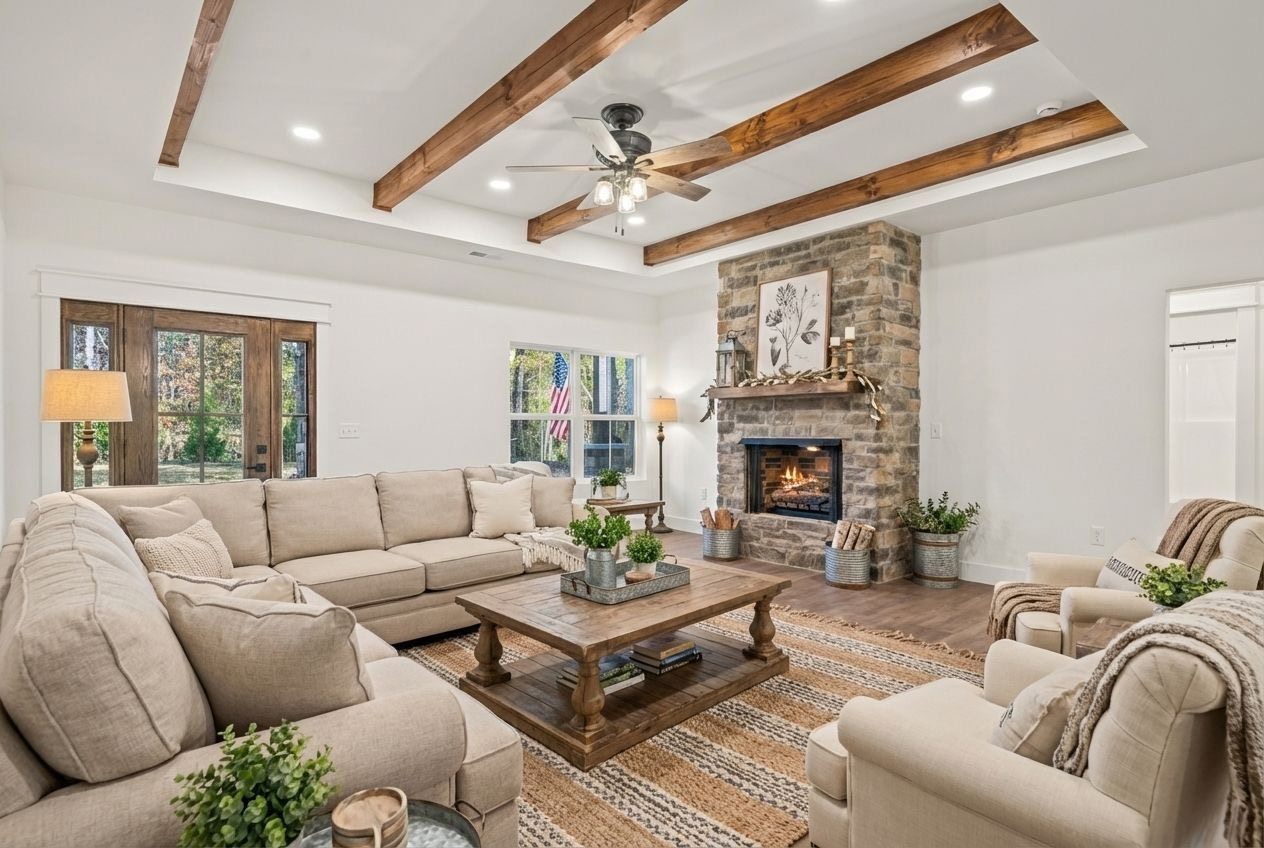 Open great room with stone fireplace and exposed wood beams
