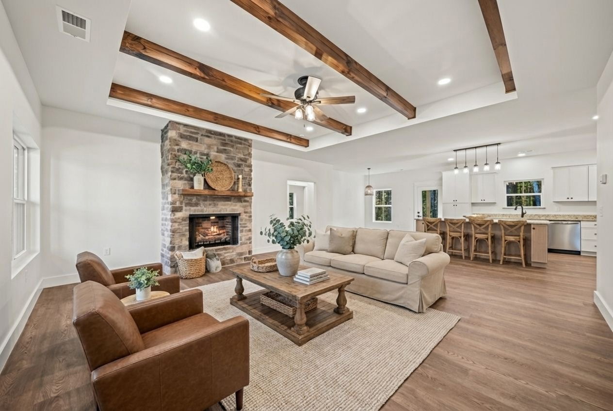 Living room open to the kitchen with beamed tray ceiling