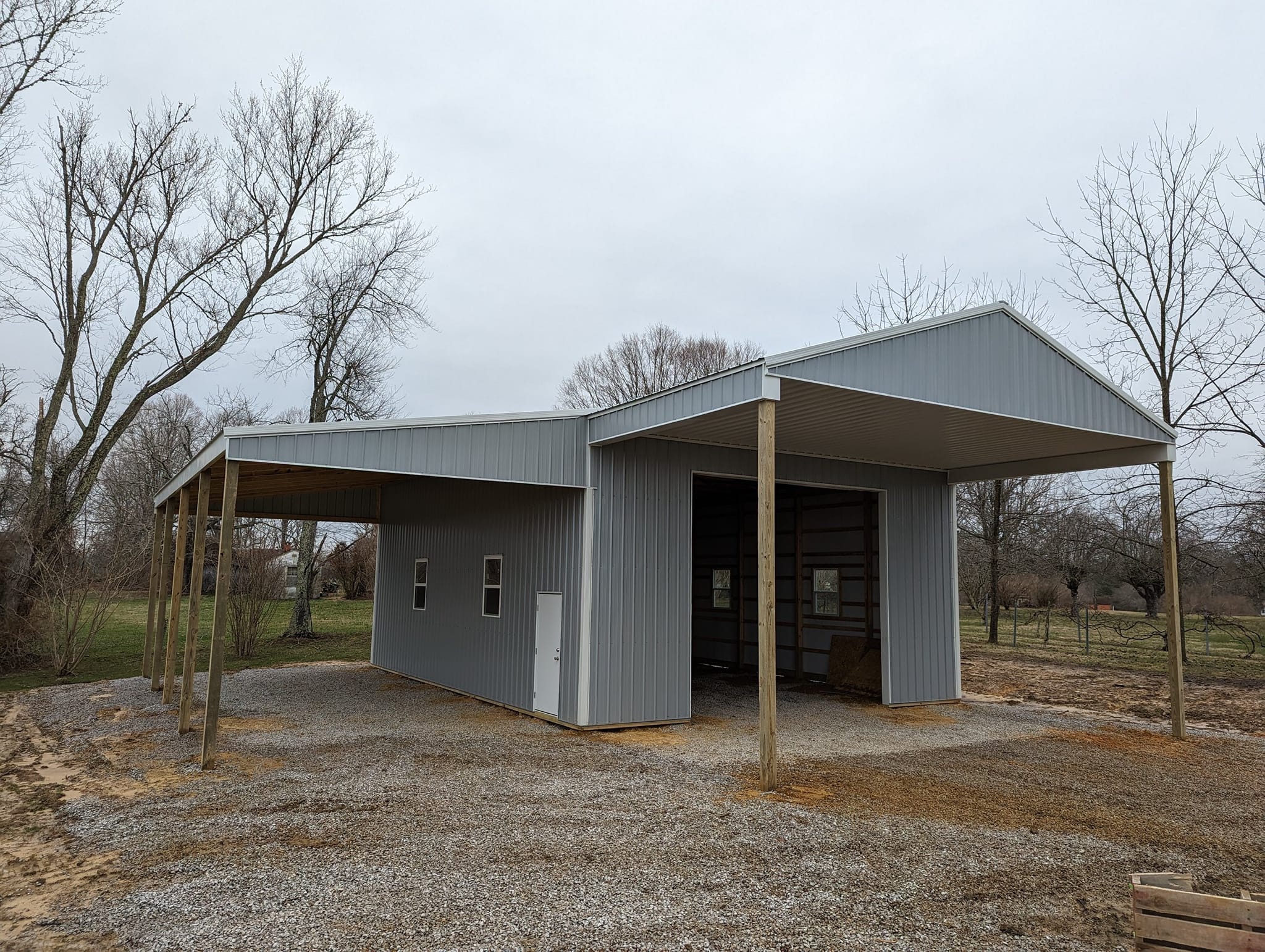 Post Frame Building with overhead door garage and overhang